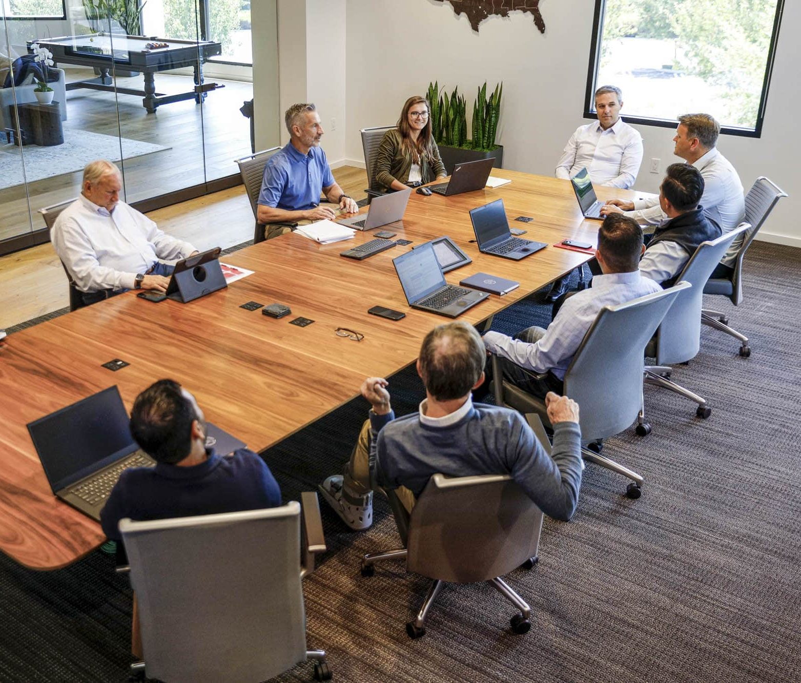 Several members of the Whitman Peterson team meeting in a conference room