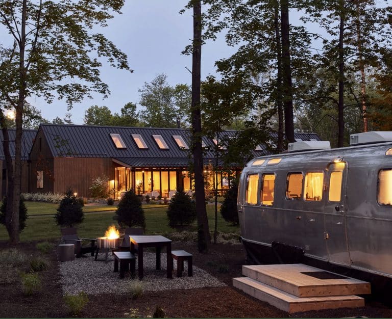 camper and cabin at a campground at night